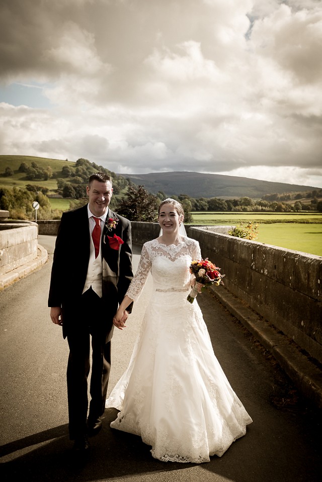 Jenny and Andy on the bridge wearing her beautiful Bespoke Amelia Gray Wedding Dress designed by Patricia Barclay